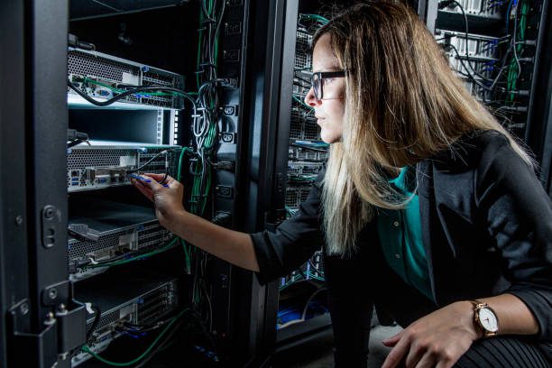 Female IT Engineer Working in Server Room.